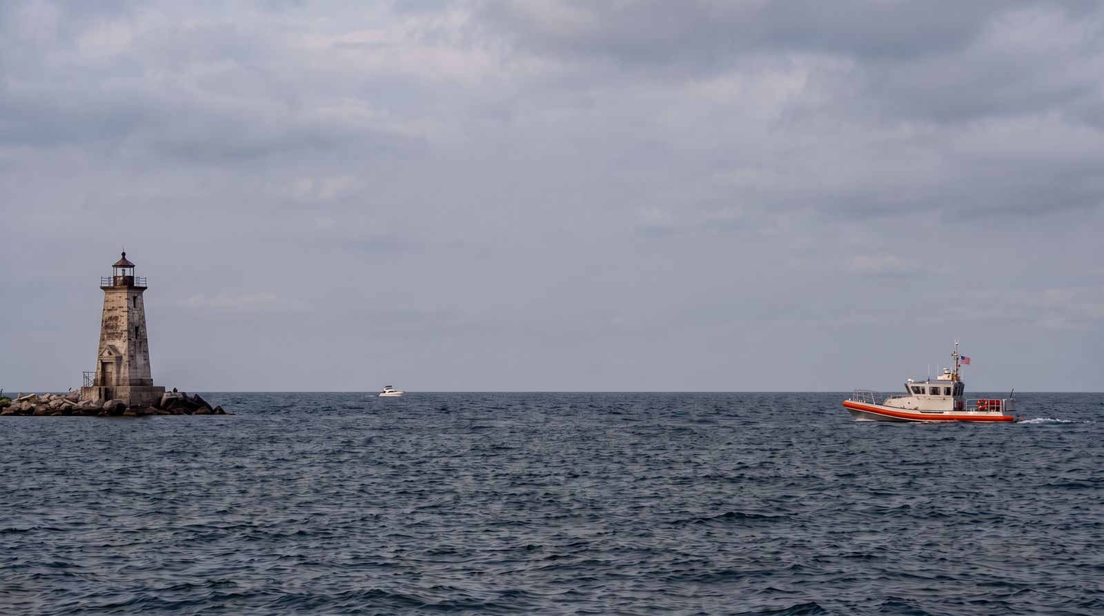 Editorial illustration of a generic patrol vessel near a lighthouse on Lake Michigan; it does not depict the defendant, an actual Coast Guard vessel, or the alleged conduct.